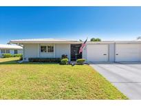 Charming single-story home with a well-manicured lawn and attached single-car garage at 3626 Medford Ln # 1537, Sarasota, FL 34232