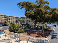 Seating area in the courtyard offering an inviting outdoor space for relaxation at 3660 Lake Bayshore Dr # K-321, Bradenton, FL 34205