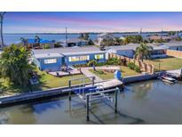 Charming waterfront home with private boat lift and dock provides Gulf access and stunning water views at 4908 Arlington Rd, Palmetto, FL 34221