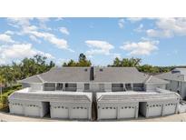 Inviting townhomes with white trim, garages and balconies create a charming facade at 1041 Capri Isles Blvd # 232, Venice, FL 34292