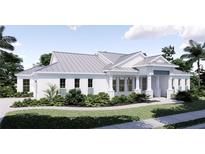 Charming single story home featuring a modern design with a light gray metal roof and lush tropical landscaping at 2508 Belvoir Blvd, Sarasota, FL 34237