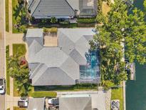 Aerial view of a home showcasing a screened pool, backyard and boat dock access to water at 4527 Barracuda Dr, Bradenton, FL 34208