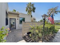 Inviting front entrance with brick paved patio, well maintained landscaping and clear numbering to locate the property at 501 Lakeside Dr # 501, Bradenton, FL 34210