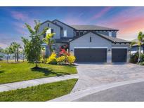 Beautiful two-story home with well-manicured lawn and a three-car garage at 5833 Millennium Silver Ct, Sarasota, FL 34238