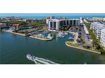 A waterfront complex featuring a boat marina and tennis courts in a scenic coastal setting at 5855 Midnight Pass Rd # 204, Sarasota, FL 34242