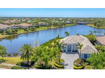 Stunning waterfront home boasts lush landscaping and a beautiful facade at 16436 Daysailor Trl, Lakewood Ranch, FL 34202