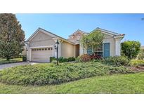 Charming one-story home features a well-manicured lawn, two-car garage, and lovely landscaping at 14404 Stirling Dr, Lakewood Ranch, FL 34202