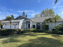 Charming single-story home with a well-manicured lawn, lush landscaping, and a classic design at 4538 Hamlets Grove Dr, Sarasota, FL 34235