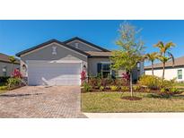 Charming single-story home with a brick driveway, two-car garage, and well-manicured landscaping at 5307 Senza Trl, Palmetto, FL 34221