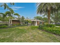 Lush lawn and landscaping frame this charming single-story home at 577 Corwood Dr, Sarasota, FL 34234
