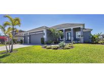 Beautiful home exterior featuring lush landscaping, modern design, and a three-car garage at 659 Rosemary Cir, Bradenton, FL 34212