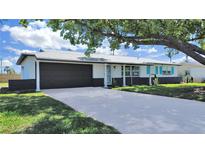 Charming single-story home with a well-manicured lawn and two-car garage at 7797 Barry Ct, Seminole, FL 33772