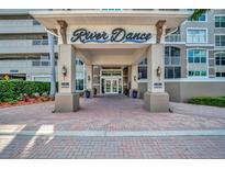 Inviting entrance to River Dance with covered portico and well-maintained landscaping at 808 3Rd W Ave # 214, Bradenton, FL 34205