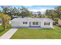Charming single-story home featuring a well-manicured lawn and a freshly painted white exterior at 923 Dawn St, Venice, FL 34285