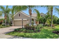 Charming single-story home with well-manicured lawn and lush tropical landscaping at 12041 Thornhill Ct, Lakewood Ranch, FL 34202