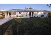 Charming single-story home featuring fresh paint, landscaping, and a well maintained front yard at 1750 Gold Ave, Sarasota, FL 34235