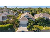 A charming home featuring lush landscaping, mature palm trees, and a well-maintained lawn at 3390 Yonge Ave # 41, Sarasota, FL 34235