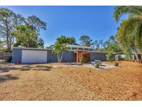 Charming single-story home with a modern aesthetic and inviting outdoor seating area at 448 58Th St, Sarasota, FL 34243