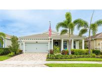 Charming single-story home featuring a two-car garage, well-manicured landscaping, and inviting front porch at 5416 Hope Sound Cir, Sarasota, FL 34238