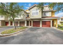 Charming townhomes showcase a tile roof and attached garages, creating an inviting curb appeal at 5691 Bentgrass Dr # 211, Sarasota, FL 34235