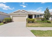 Charming single-story home featuring a well-manicured lawn and an attached two-car garage, offering comfort and convenience at 6381 Mighty Eagle Way, Sarasota, FL 34241