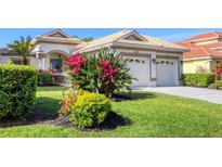 Charming single-Gathering home featuring a two-car garage, colorful landscaping, and a well-maintained lawn at 6458 Tailfeather Way, Bradenton, FL 34203