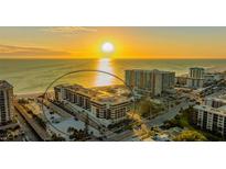 Stunning aerial view of a beachfront condo complex at sunset with direct beach access and beautiful architecture at 1104 Benjamin Franklin Dr # 519, Sarasota, FL 34236