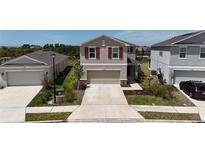 Charming two-story home featuring red shutters, neutral paint, and a spacious two-car garage at 11252 Fieldstone Dr, Palmetto, FL 34221