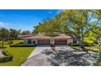 Charming home featuring a two-car garage and lush landscaping on a sunny day at 4463 Atwood Cay Pl # 22, Sarasota, FL 34233
