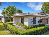 Charming single-story home with white exterior, manicured hedges, and well-maintained front yard at 4463 Atwood Cay Pl # 22, Sarasota, FL 34233