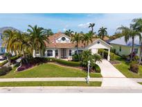 Charming single-Gathering home with a manicured lawn, mature palms, and inviting curb appeal at 4741 Pinnacle Dr, Bradenton, FL 34208