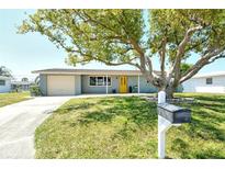 Charming single-story home with a well-maintained lawn and a vibrant yellow front door at 568 Sheridan Dr, Venice, FL 34293