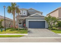 Charming two-story home featuring a well-manicured lawn and an attached two-car garage at 5759 Bungalow Grove Ct, Palmetto, FL 34221