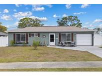 Charming single-story home featuring a well-maintained lawn, inviting front door, and attached garage at 8718 Gaillard Ave, North Port, FL 34287