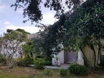 Charming home exterior with lush landscaping and a welcoming front entrance at 1167 Fraser Pine Blvd, Sarasota, FL 34240