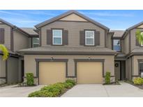Charming two-story townhouse with attached two-car garage and well-manicured landscaping at 11828 Sky Acres Ter, Bradenton, FL 34211