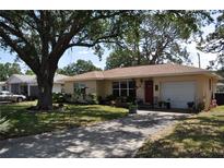 Charming single-story home with a well-manicured front yard and mature trees for shade at 1711 30Th W St, Bradenton, FL 34205