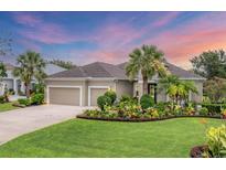 Charming single-story home with a well-manicured lawn, tropical landscaping and a two car garage at 1727 88Th Nw Ct, Bradenton, FL 34209