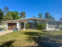 Charming one-story home with attached garage, well-kept lawn, and lush trees in a beautiful neighborhood at 2707 52Nd Avenue W Ter, Bradenton, FL 34207