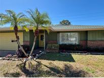 Charming home featuring palm trees, a well-maintained lawn, and inviting curb appeal at 2712 52Nd Avenue W Ter, Bradenton, FL 34207