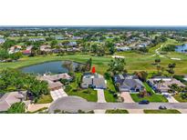 Stunning aerial view of home with pool, fire pit, golf course, and water features in beautiful Venice, Florida at 3725 Spyglass Hill Rd, Sarasota, FL 34238