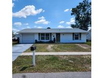 Charming single-story home with a manicured lawn and a classic design at 4070 Grobe St, North Port, FL 34287