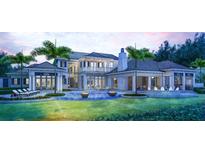 Expansive backyard featuring a luxury pool with fire bowls and lush landscaping, perfect for relaxation at 4214 Higel Ave, Sarasota, FL 34242