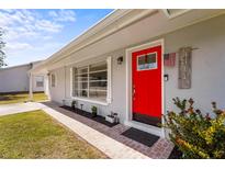 Bright red front door and brick path of this charming home enhance the curb appeal and invite a warm welcome at 4311 2Nd E Ave, Bradenton, FL 34208