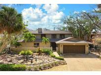 Charming two-story home with well-maintained landscaping, mature trees and two car garage at 4711 Ocean Blvd, Sarasota, FL 34242