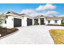 Stunning single story home with a three-car garage, brick driveway and tasteful landscaping at 1007 143Rd Ne St, Bradenton, FL 34212