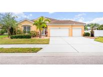 Beautiful one-story home featuring a well-manicured lawn, tiled roof, and a spacious driveway at 1189 Fraser Pine Blvd, Sarasota, FL 34240