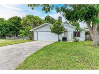 Charming single-story home with a well-manicured lawn and an attached two-car garage at 2601 13Th W St, Palmetto, FL 34221