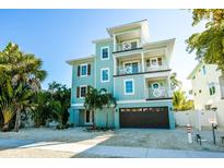 Beautiful three-story coastal home with multiple balconies and a convenient ground-level garage at 336 Avenida De Mayo, Sarasota, FL 34242