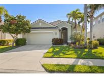 Charming single-story home features a well-maintained lawn, mature landscaping, and an attached two-car garage at 3752 Summerwind Cir, Bradenton, FL 34209